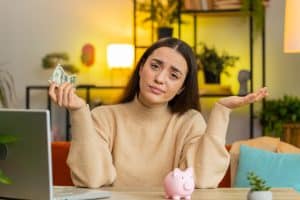 young woman doesn't have enough money to count on Inflation impact on household budgets 