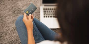 woman holding a Citi Strata Premier card.