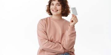WOMAN holding a Wells Fargo Active Cash card.